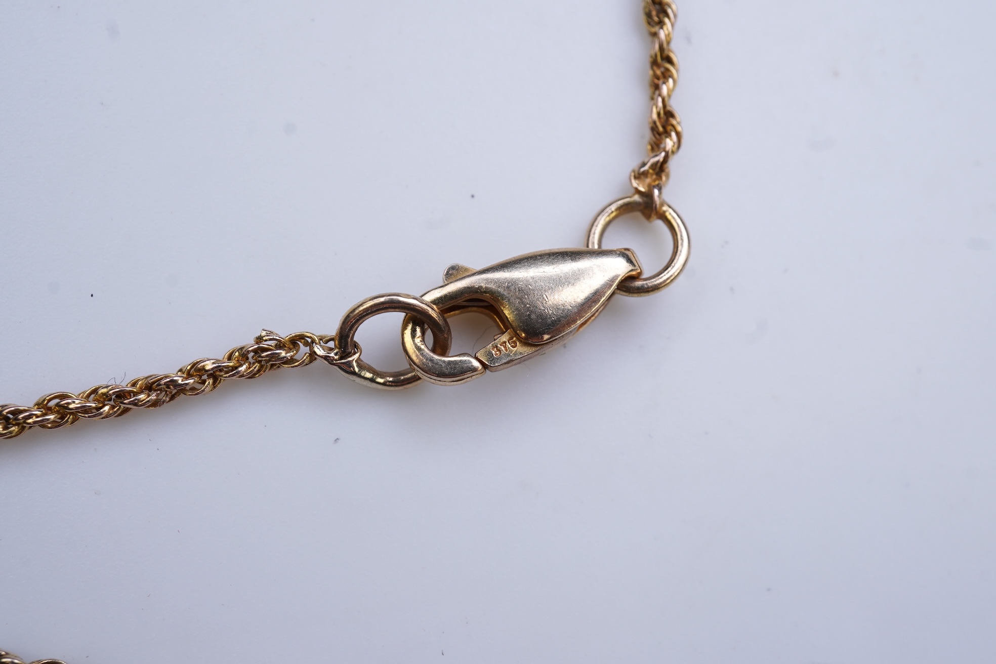 A synthetic colour-change sapphire and diamond pendant necklace